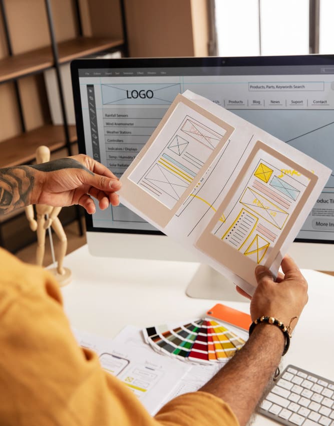 Hands-holding paper that contain design structure of the website